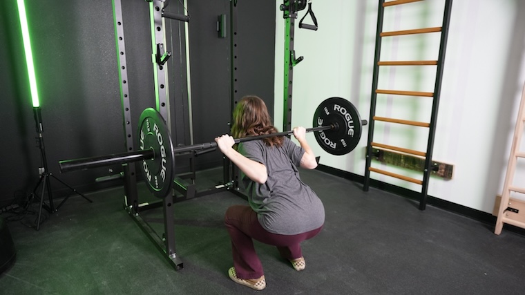 Our tester squatting with the Major Fitness 20kg 7’ Home Gym Barbell