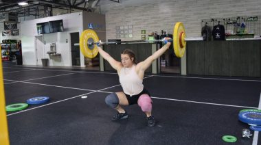A person doing weightlifting exercises in the gym.
