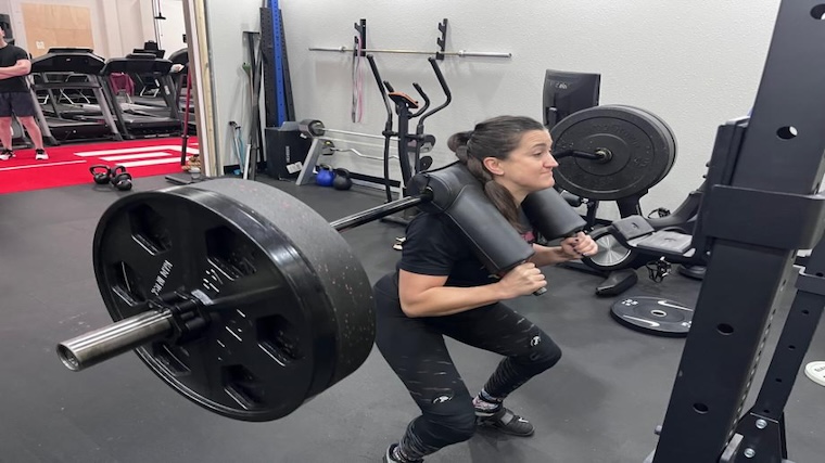 Kate Meier squatting with the Bells of Steel SS4 safety squat bar