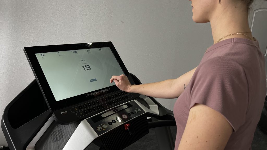 A close up view of our BarBend Tester using the touchscreen on a ProForm Pro 9000 treadmill.