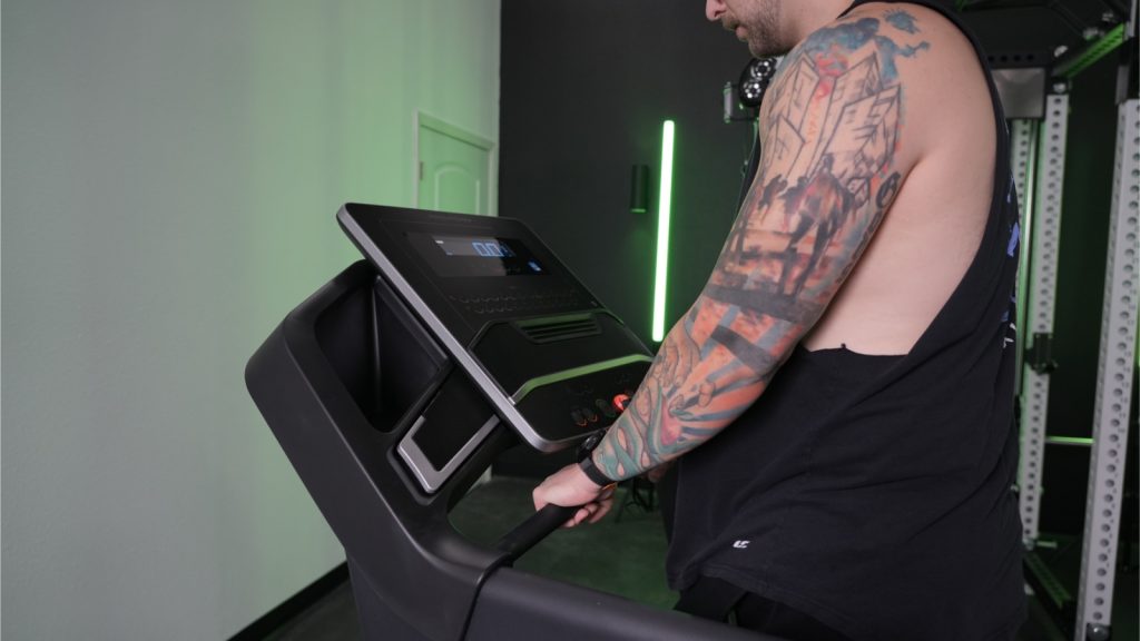 A close up view of a person holding the heart-beat bars on the ProForm Carbon TLX treadmill.