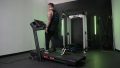 A BarBend tester walking on a ProForm Carbon TLX treadmill.