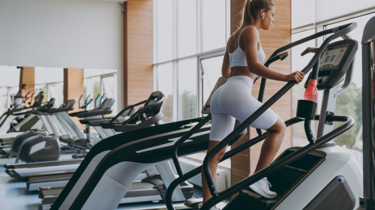 A fit person working out on a stairmaster. 