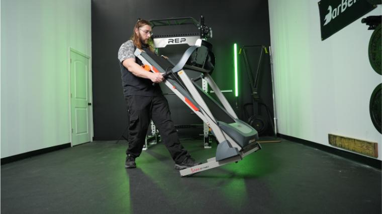 A person moving the Sunny Health & Fitness SF-T4400.