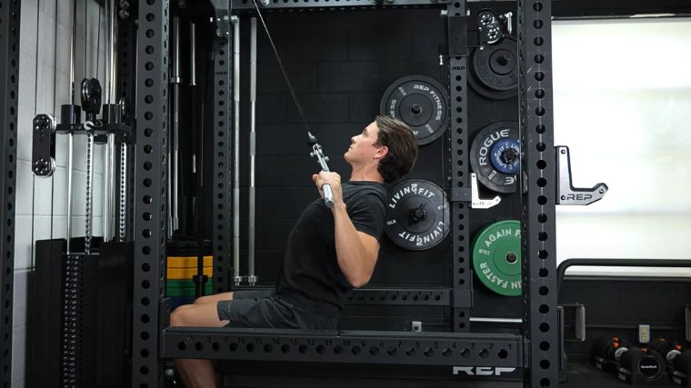 A person performing the wide-grip lat pulldown exercise.