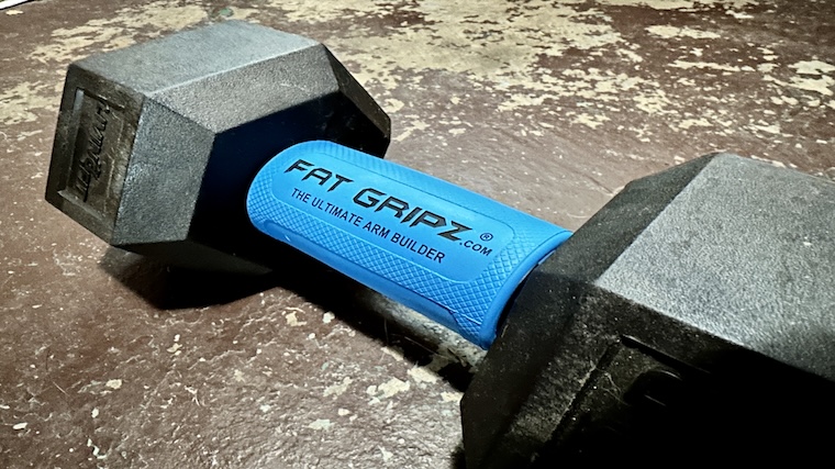 The Fat Gripz Pro Grip Strengthener set over a dumbbell handle