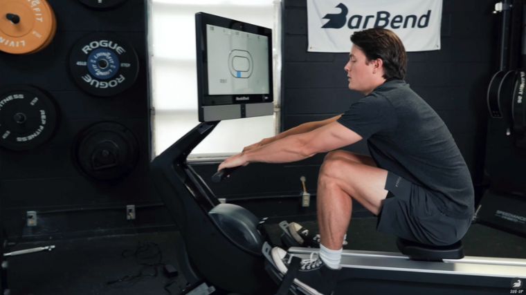 A person working out on a rowing machine.