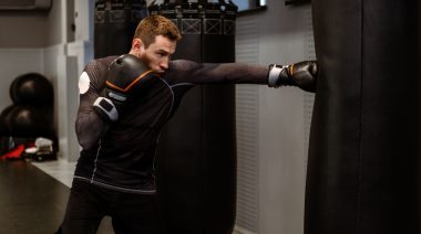 A person punching a heavy bag in the gym.