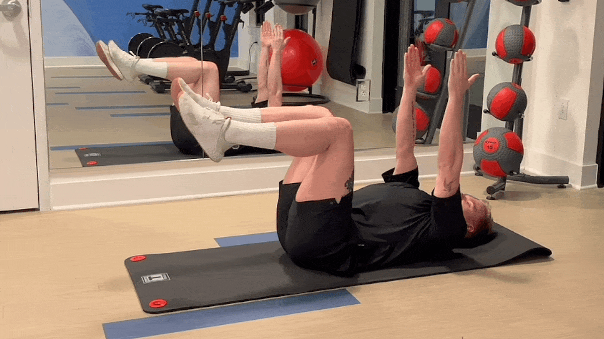 A person performing the dead bug exercise.