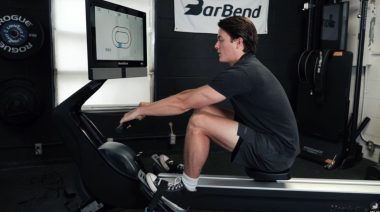 Our tester using a rowing machine in the BarBend gym.