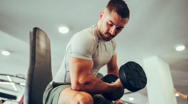 A bodybuilder focused on their workout.