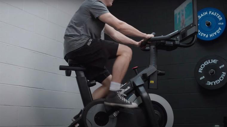 BarBend lead video reviewer Jake Herod, NASM-CPT, riding the NordicTrack S22i.
