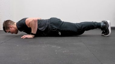A person doing push-ups as part of a Pilates workout.