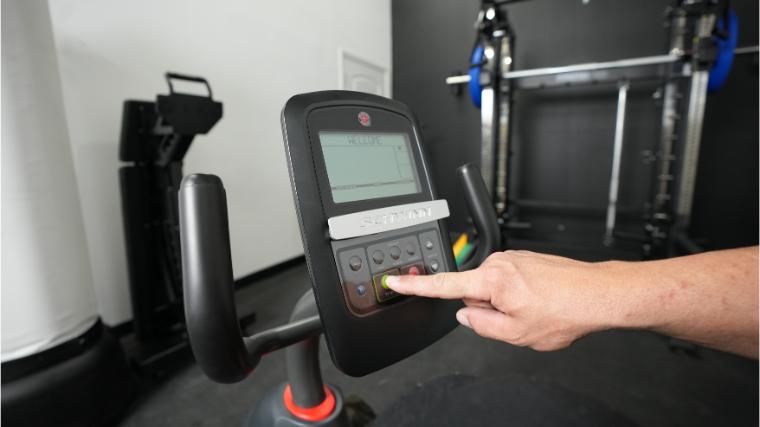 Our BarBend tester using the LCD display and media shelf on the Schwinn 230.