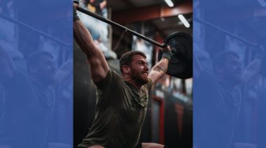 A CrossFit athlete lifting a barbell