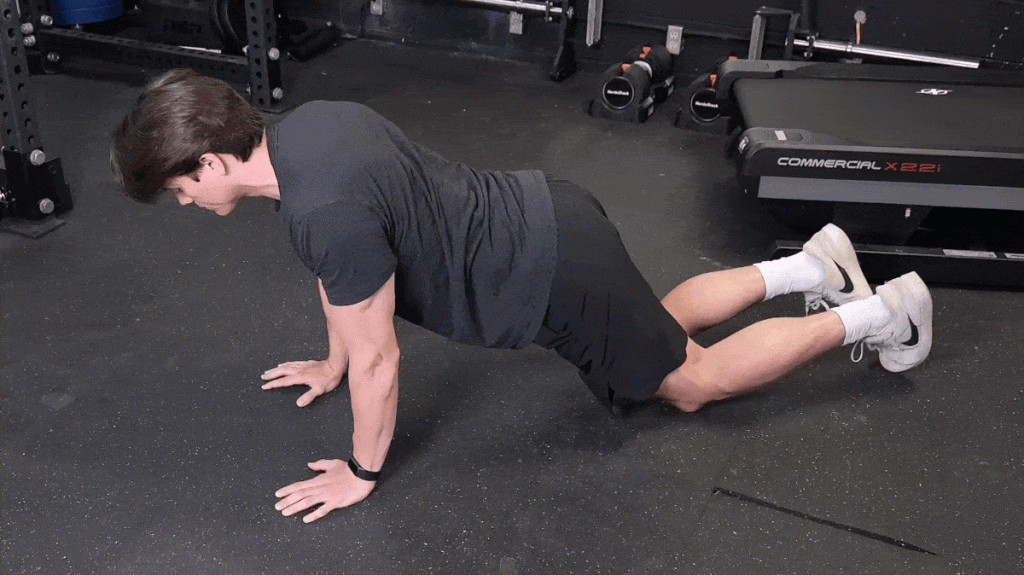 An athlete performing the assisted push-up exercise.