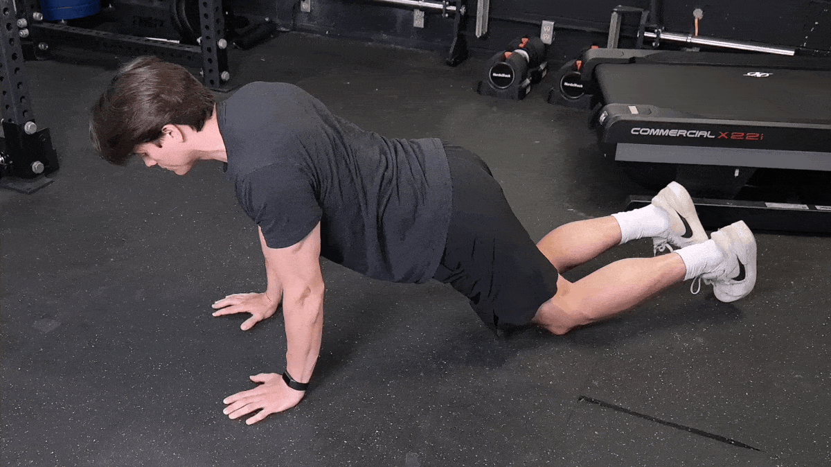 A person doing the assisted push-up exercise.