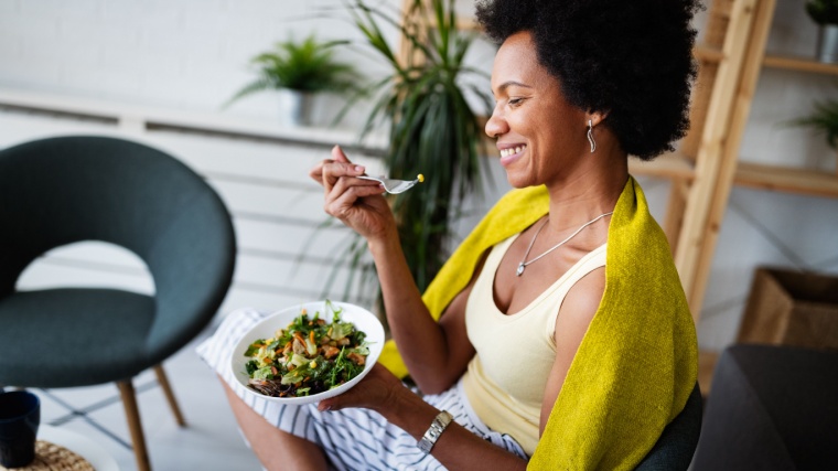 A person eating a healthy meal while sitting on a chair.