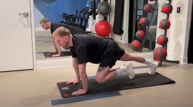 A person performing the mountain climber exercise as part of a HIIT cardio workout program.