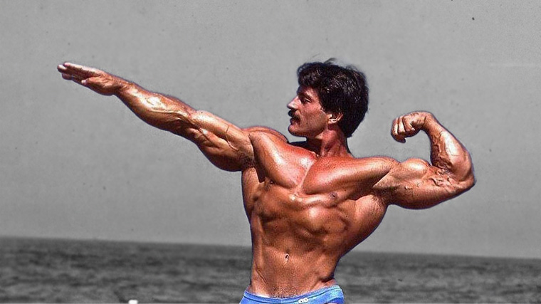 Bodybuilder Mike Mentzer posing on a beach.