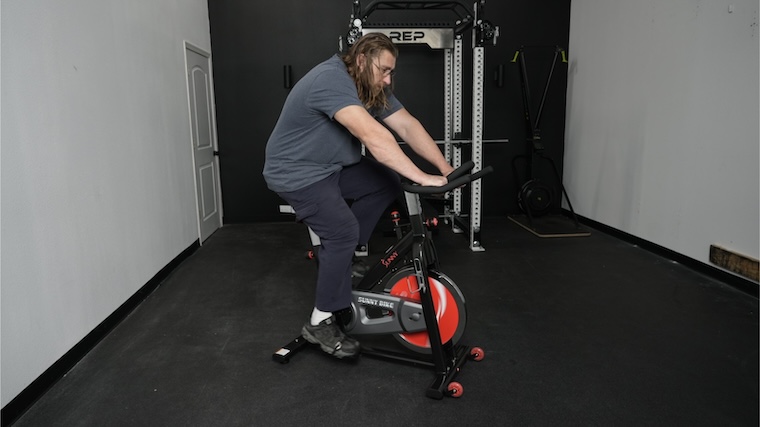 Our tester working out atop the SF-B1002 exercise bike from Sunny Health and Fitness