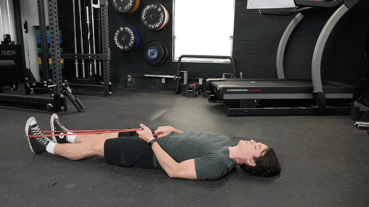 A person doing the supine IT band stretch.