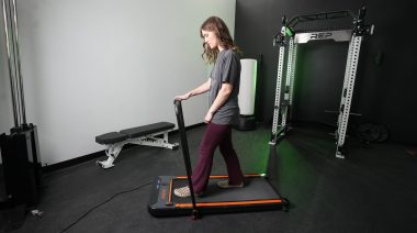 a person walking on a UREVO treadmill