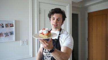 Will Tennyson holds up dessert in his kitchen.