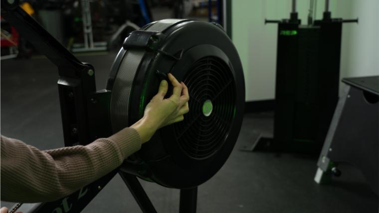 Our tester adjusting the resistance on the Concept2 RowErg.