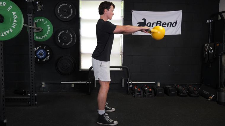 A person performing the kettlebell swing exercise.
