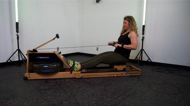 Our tester using the Merach 950 Rower.