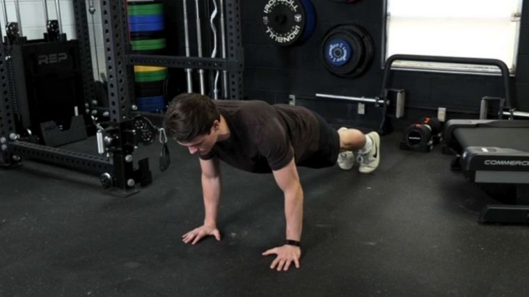 A person planking to gain the benefits of Pilates workout.