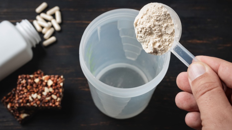 A person making a protein shake.