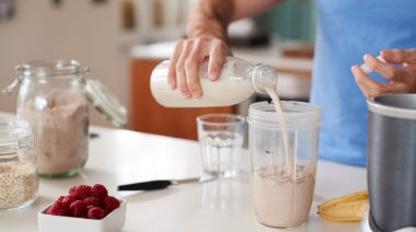 A person making a protein shake.