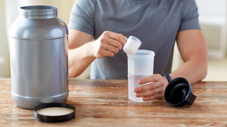 A person making a protein shake.