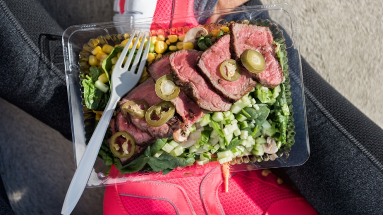 Food consisting of meat and vegetables in an open lunch box.