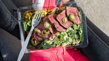 Food consisting of meat and vegetables in an open lunch box.