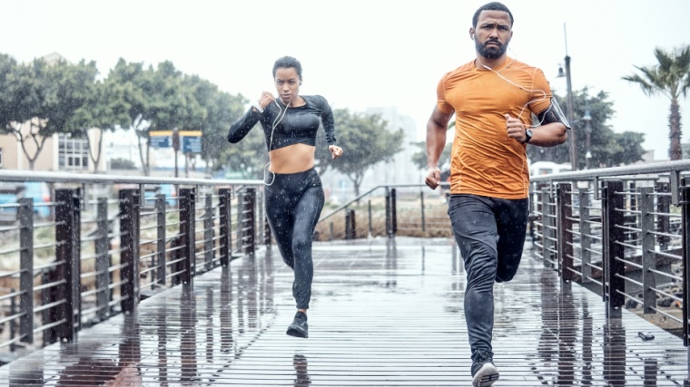Two people running in the rain.