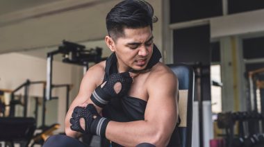 Why Does Pre-Workout Make You Itch? A person checking their arm at the gym for signs of allergic reaction.