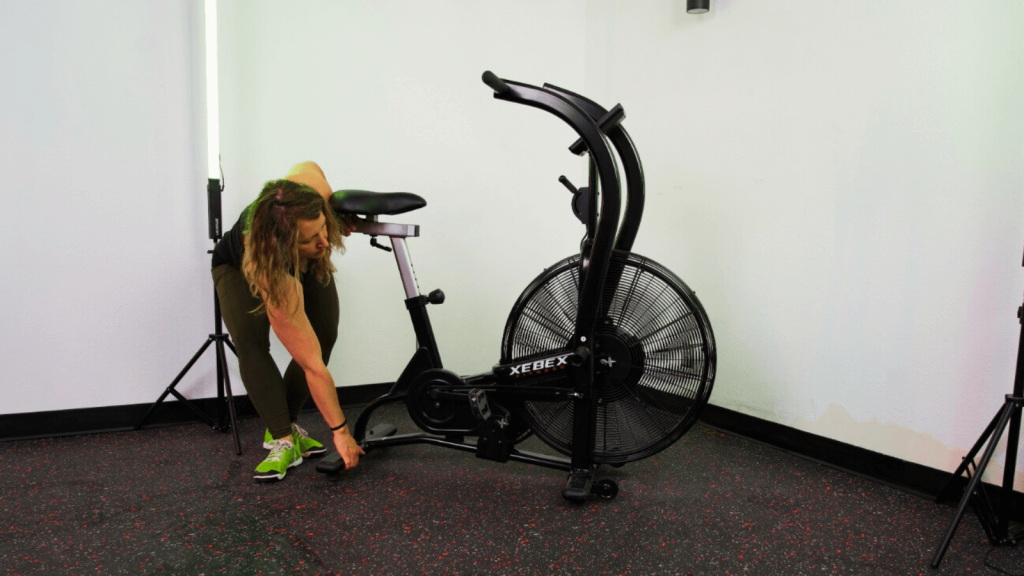 An athlete adjusting the Xebex AirPlus Performance Bike. 