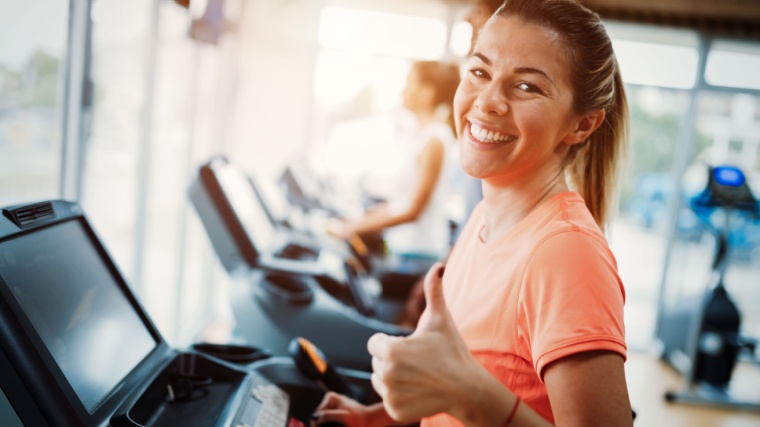 Woman gives thumbs-up on treadmill