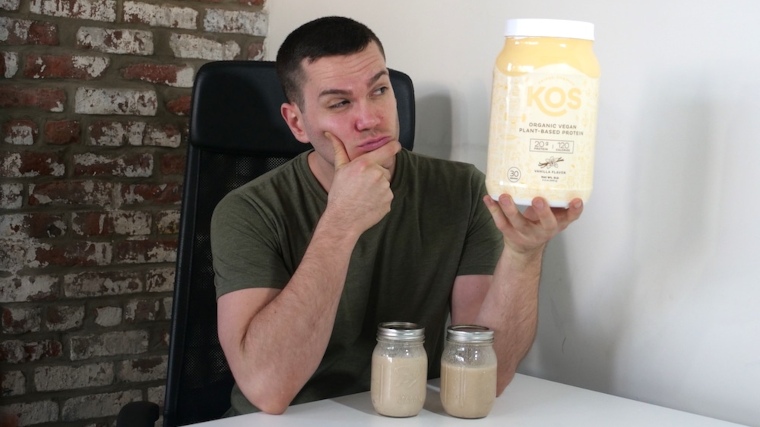 Our tester holds a container of KOS Organic Plant Protein.