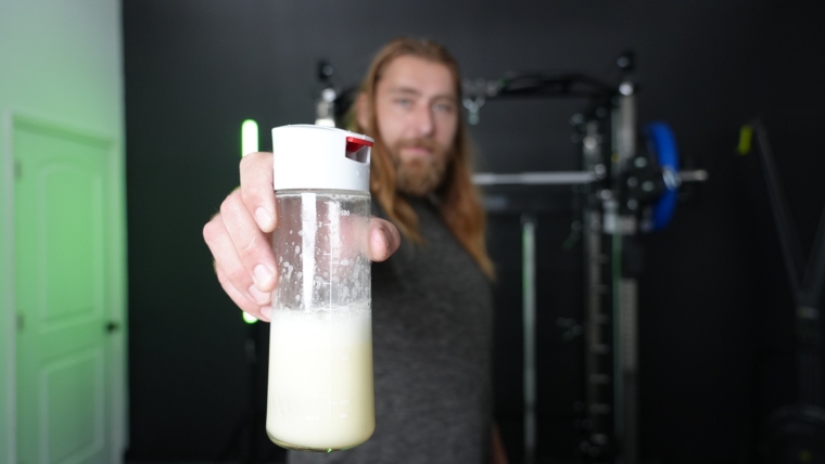 Our tester holds up a shaker bottle of Naked Nutrition's Naked Egg.