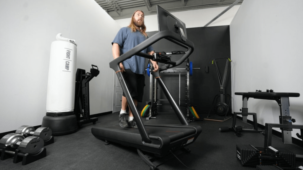 A person walking on the Peloton Tread treadmill.