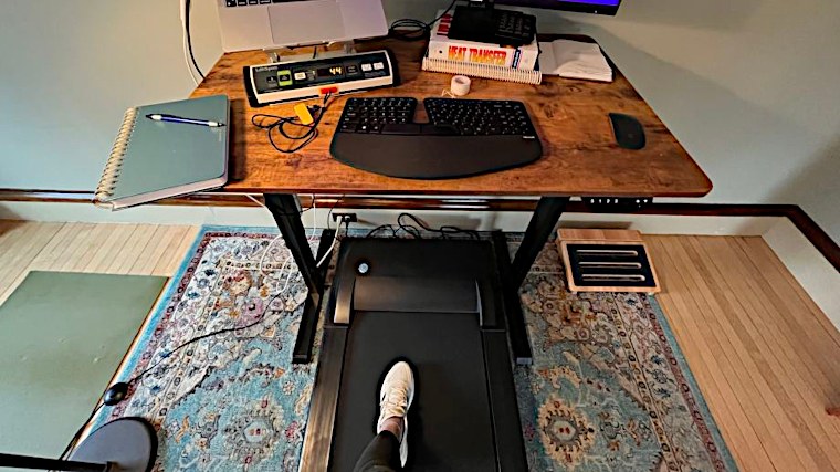 Looking down at a desk and working on a treadmill