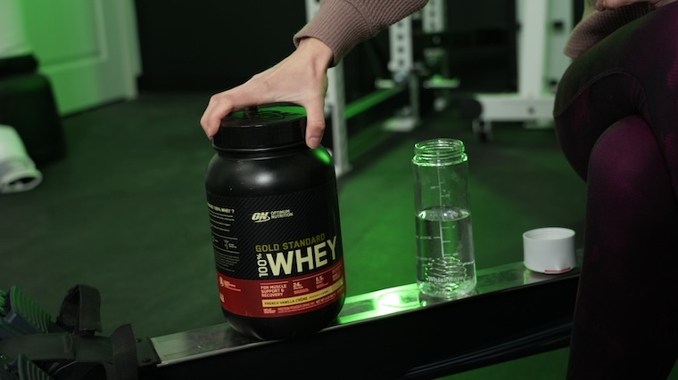 Our tester with a container of Optimum Nutrition Gold Standard Whey