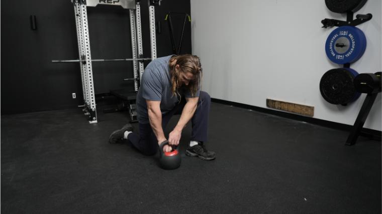 Our tester adjusting the weight on the REP Fitness Adjustable Kettlebell.