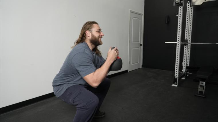 Our tester performing a goblet squat with the REP Fitness Adjustable Kettlebell.