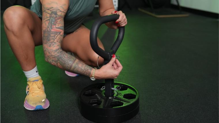 Our tester loading the Titan Fitness Plate Loadable Kettlebell.