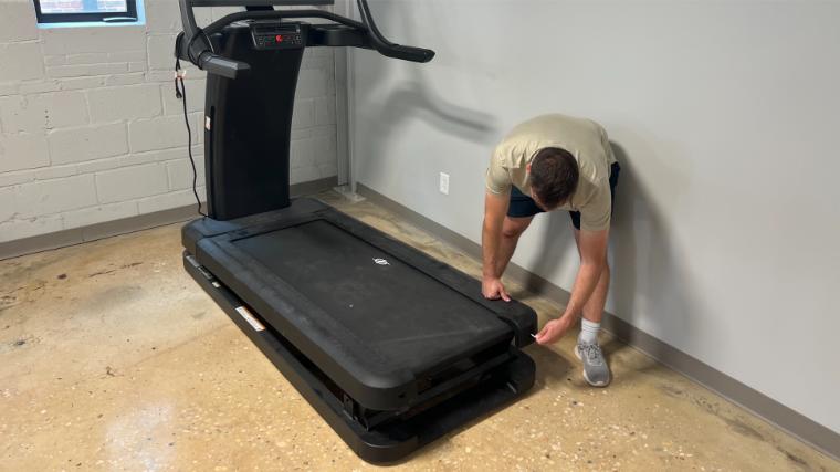 Our tester adjusting the belt of the NordicTrack x32i Treadmill.